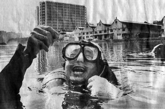 Loh Seng Chong holding up a guppy